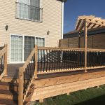 Deck on a house with brown vinyl siding