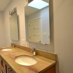 Bathroom with brown counter and two sinks