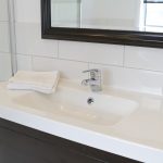 Bathroom with white sink and white tiles