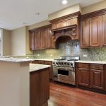 Kitchen with dark cabinets and marble counters