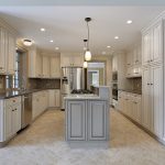 Large white kitchen with stainless appliances