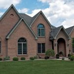 large brick house with green trim