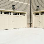 Grey siding and large garage door